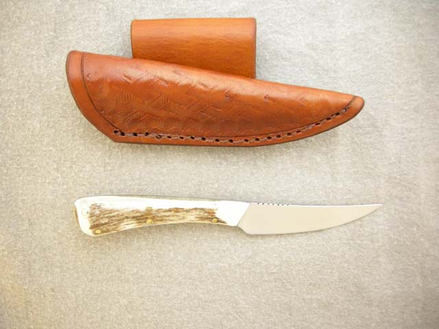 Sheath made to hang on Traditional Back quiver strap as a neck knife    without the little cord dangeling and flopping around. Much more secure.